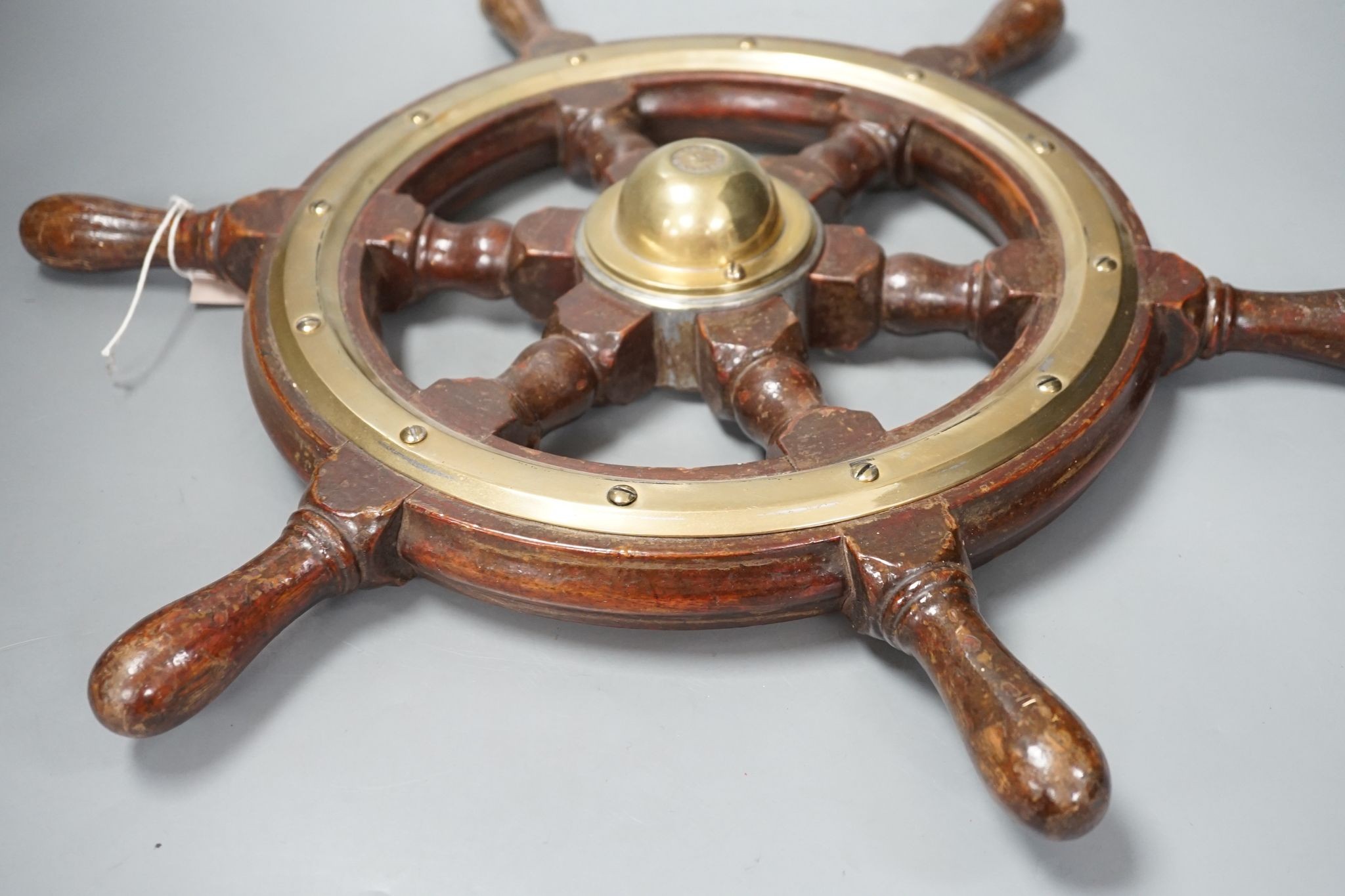 A hardwood and brass mounted Ship's wheel, signed Lawrence Simpson 50cm